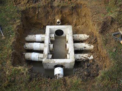 Photo of concrete distribution box installed as part of Statewide Environmental Services septic parts replacement service.