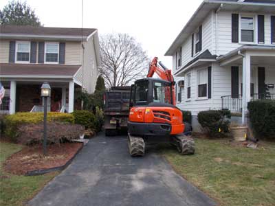 Photo of orange tractor and black truck used by Statewide Environmental Services in performance of their residential oil tank and septic system services.