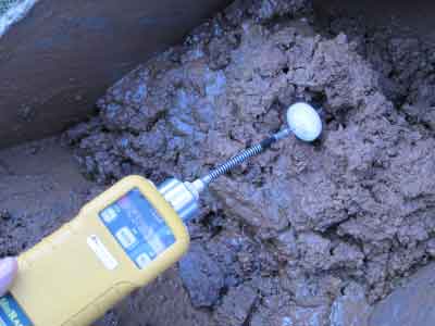 Photo of yellow meter used to test the soil surrounding an underground oil tank for possible contamination.