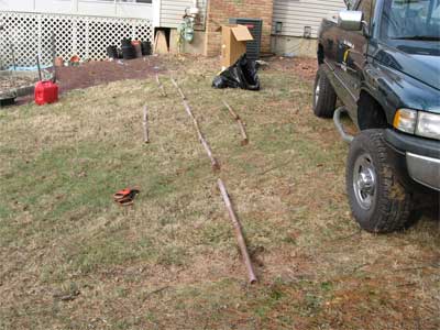 Photo of pipes on lawn of residential property in preparation of soil testing for contaminants.